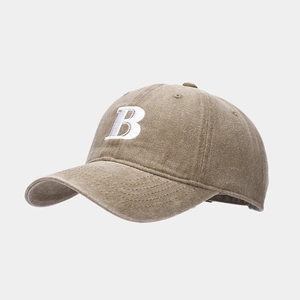 Detail of embroidered white letter B on a coffee brown vintage cotton baseball cap
