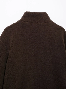 Detailed view of deep brown teddy fleece jacket collar and plush texture detail