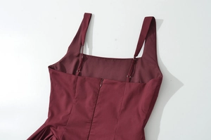 Detailed back view of a burgundy dress featuring hidden zipper and wide shoulder straps