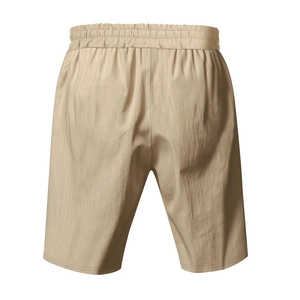 Detail view of khaki casual beach shorts featuring an elastic drawstring waistband and nylon texture