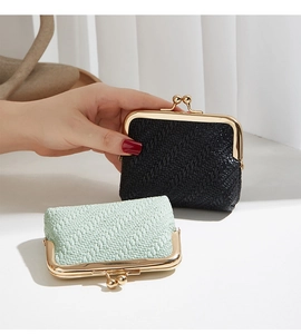 Detail showing black and mint green woven coin purses with vintage golden kiss-lock closure
