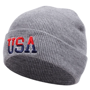 Close-up of grey knit beanie featuring detailed USA embroidery on the folded cuff