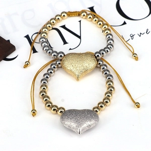 Adjustable heart charm bracelet with gold and silver beads and frosted heart pendant