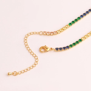 Detailed macro view of colorful zircon tennis chain with gold lobster clasp and extension