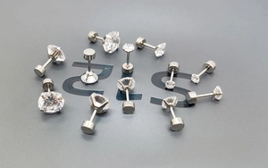 Macro detail of various sizes of 316L stainless steel labret studs with cubic zirconia