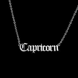 Detailed macro of Capricorn gothic letter pendant on a silver stainless steel chain