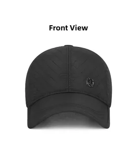 Detail of black quilted baseball cap with metallic shield logo and lattice stitching