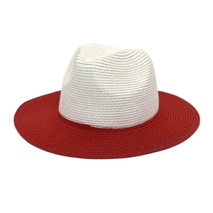 Detail of two-tone panama straw hat with fine woven texture and wide red brim