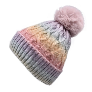 Close-up of thick cable knit texture and colorful gradient pom pom beanie on white background