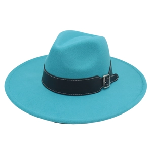 Detail of turquoise fedora hat with black leather band and silver buckle on white background
