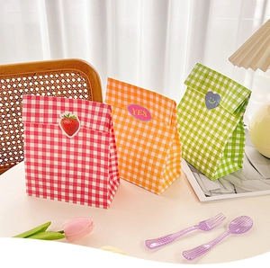 Detailed shot of checkered kraft gift bags in red, orange and green with cute stickers