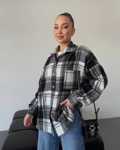 Detailed view of the checkered plaid pattern and thick wool-like fabric on the long sleeve shirt