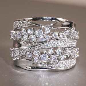 Macro shot of multi-layer crisscross silver ring with shimmering pavé zircon stones