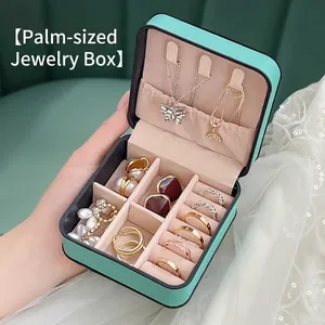 Portable mint green leather jewelry box for girls held in hand with travel-size design