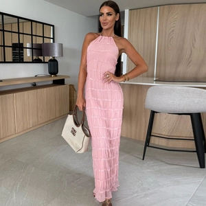 Detail of pink backless halter maxi dress with ruched fabric and ruffled hemline