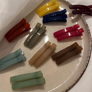 Morandi color rectangular resin hair clips set in a cream ceramic tray, minimalist style