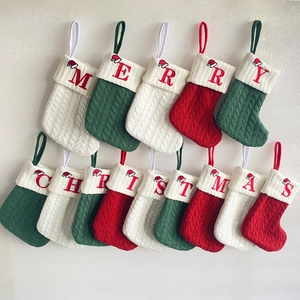 Set of 14 knitted Christmas stockings in red, green and white with embroidered letters