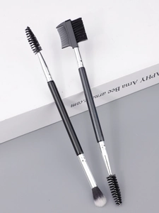 Detailed view of professional dual-ended eyebrow brushes and lash combs for makeup