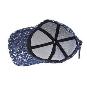 Detail view of navy sequin baseball cap interior with reinforced black stitching
