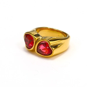 Close-up of gold titanium steel ring featuring two red heart-shaped gemstones