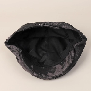 British retro tie-dye distressed flat cap in black washed denim with frayed edges