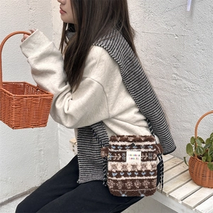 Soft plush crossbody bag featuring a Nordic diamond pattern and a durable woven strap