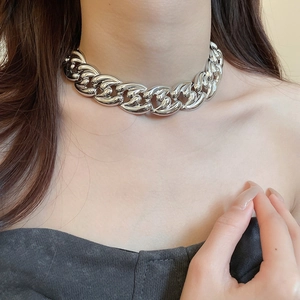 Close-up of polished silver chunky chain necklace in Cuban style on model