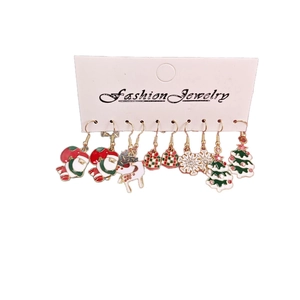 Christmas earring set with Santa Claus, reindeer, and snowflakes on a white background