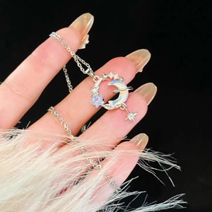 Detail showing moon and star necklace with rainbow opal stone and sparkling zircon accents