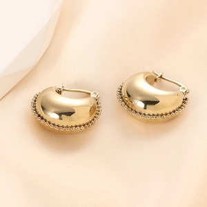 Detail of 14K gold plated stainless steel C-shaped hoop earrings with beaded edge