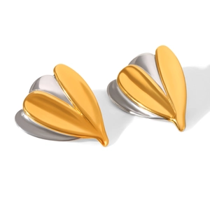 Detail of two-tone gold and silver leaf earrings with a polished metallic finish