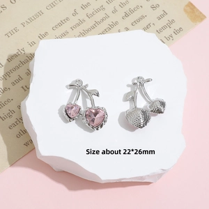 Detailed view of Y2K cherry pendant with pink heart crystal and silver textured back
