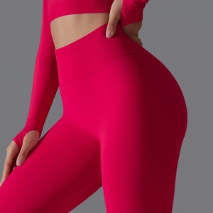 Detailed side view of high-waisted red ribbed yoga leggings showing booty lifting effect