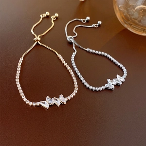 Adjustable zircon butterfly bracelet in gold and silver finish on leather texture