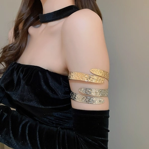 Close-up of retro arm cuff featuring detailed floral relief and metallic texture