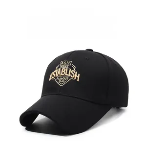 Detail of premium gold shield embroidery with ESTABLISH text on a black baseball cap