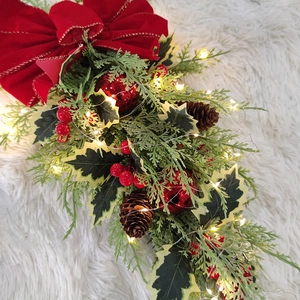 Christmas teardrop wreath with pine leaves, red berries, cones and warm LED lights