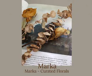 Macro shot of dried rose and eucalyptus leaves on a vintage magazine for product photography