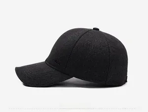 Detail view of dark grey wool baseball cap showing premium texture and metal side plate