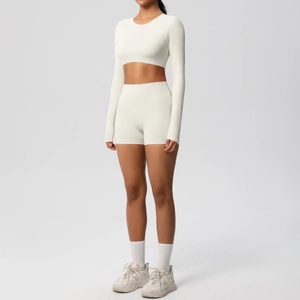 Detail view of white brushed yoga set featuring long sleeve crop top and high waist shorts