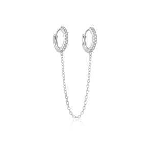 Macro shot of silver double piercing earrings with CZ chain and polished clasp detail
