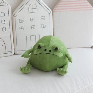 Close-up of the green plush frog showing its sad face expression and soft fabric texture