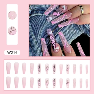 Detailed view of pink ballerina press-on nails with butterfly and cherry rhinestones