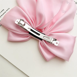 Pink satin bow hair clip with a long tail and a durable metal spring clasp for women