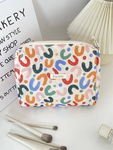 Close-up of quilted floral makeup bag with U-shaped patterns and zipper detail