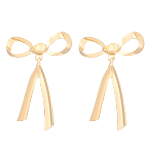 Polished gold ribbon bow earrings with delicate dangling tails on white background