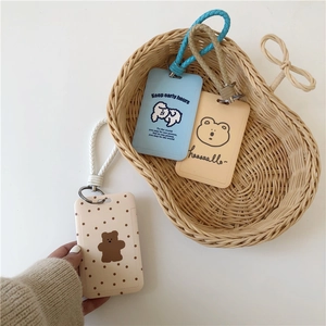 Cute bunny and bear plush card holders with woven lanyards in a blue aesthetic basket