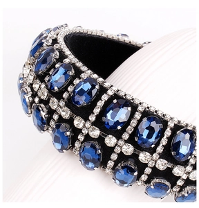 Detailed close-up of Baroque velvet headband with blue gems and crystal lattice