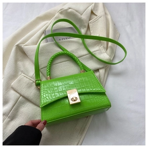 Detailed macro view of fluorescent green croc-embossed leather with gold twist lock