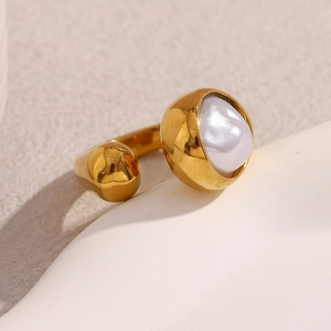 Detail of 18K gold plated snake head open ring with a lustrous white pearl on stone